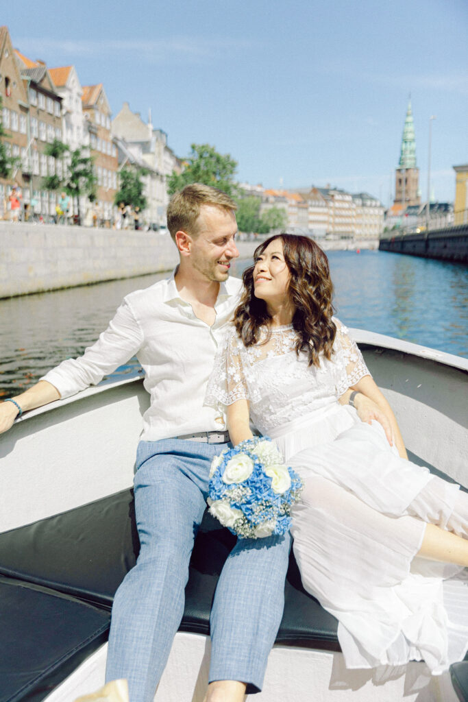 Couple get married in Copenhagen boat tour in canal in summer
