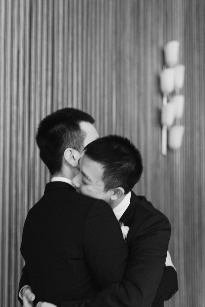Same gender homosexual couple get married in Frederiksberg city hall hugging each other